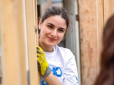 woman building a house with Changemakers committee