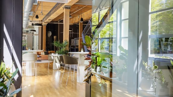 Impact Report image that shows an office shared space in warm and natural tones