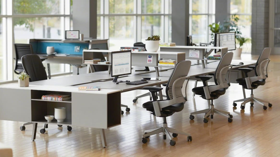 Work area with white collaborative desks and blue Leap chairs