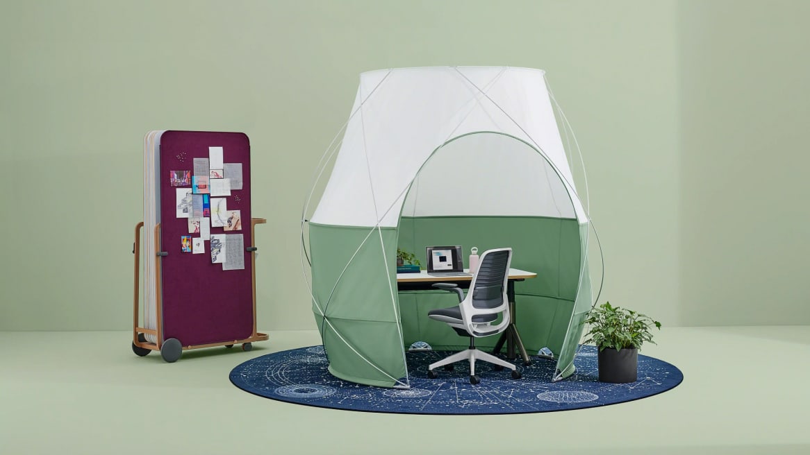 Green pod tent with an Amia office chair inside
